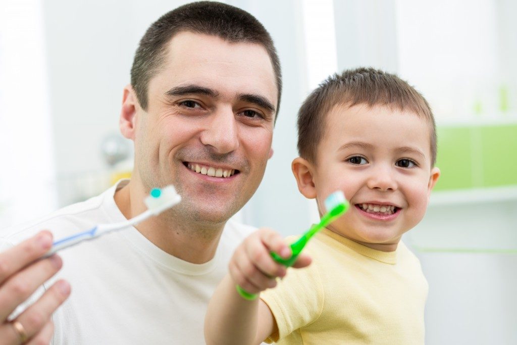 Father and son about to brush their teeth