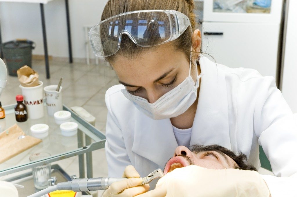 Dentist checking the patient's teeth