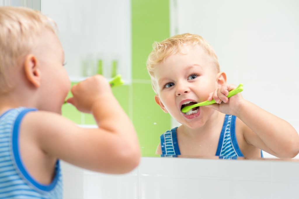 a kid brushing their teeth