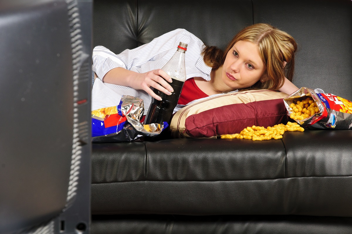 woman eating chips and drinking softdrinks