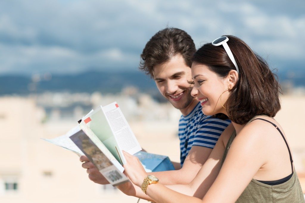 Tourist couple looking at a brochure