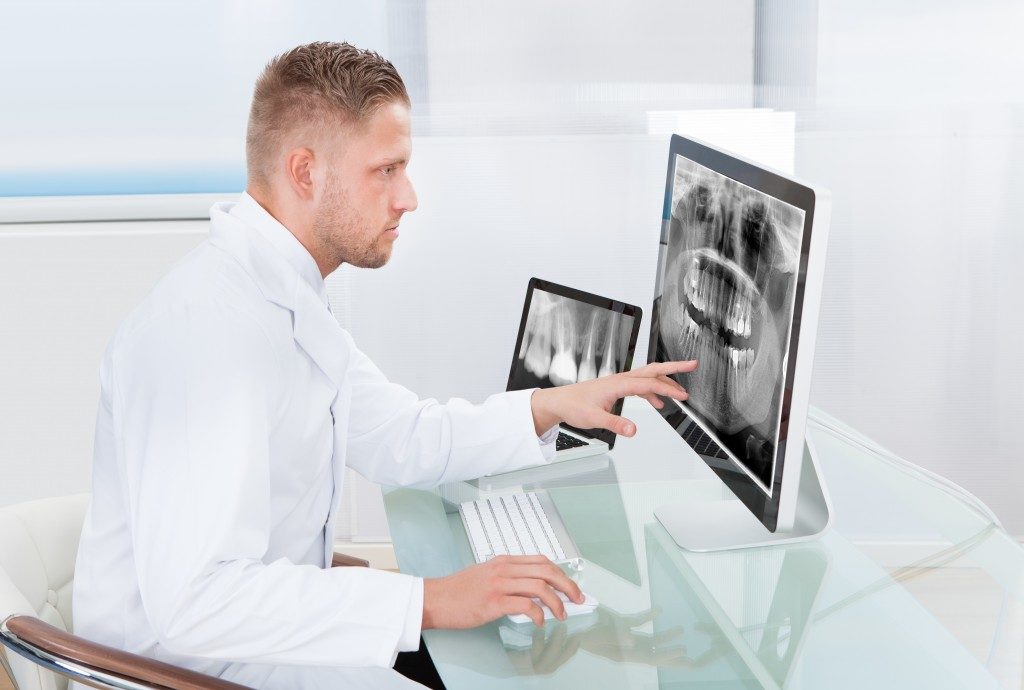 radiologist looking at an x-ray