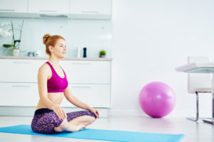 woman doing yoga at home