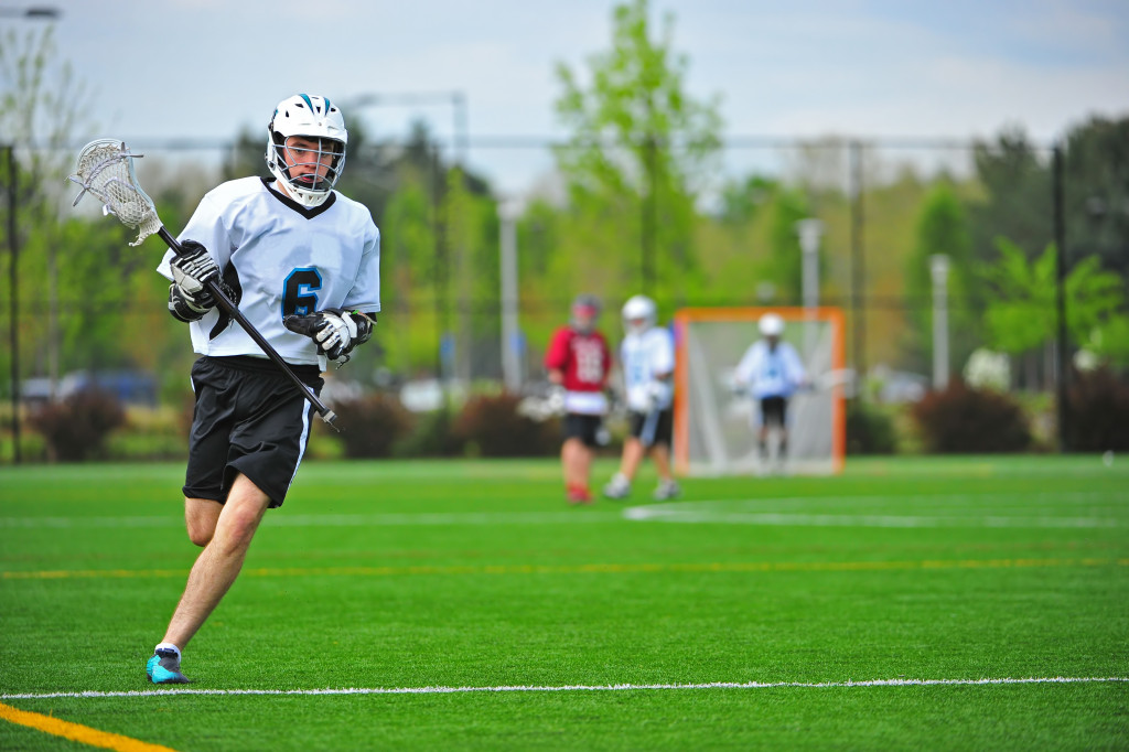 lacrosse player in the field playing with team