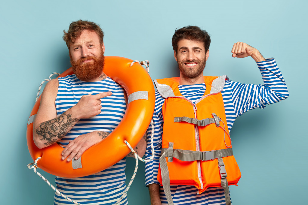 Two swimmers wearing a floater and a life jacket