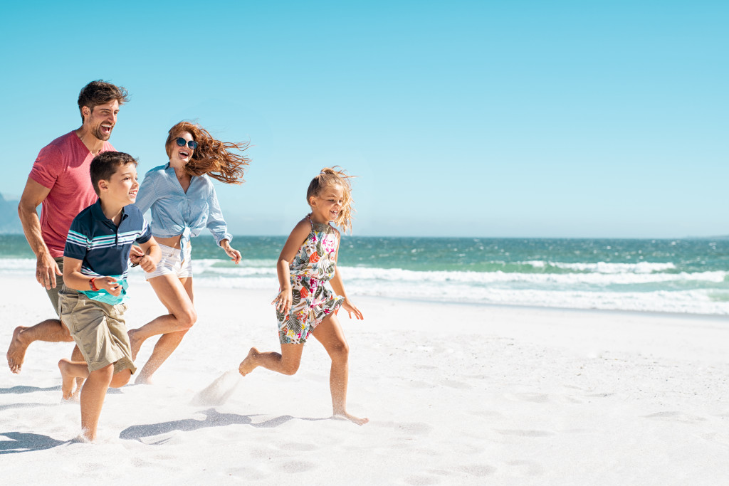 A happy family running at a beach